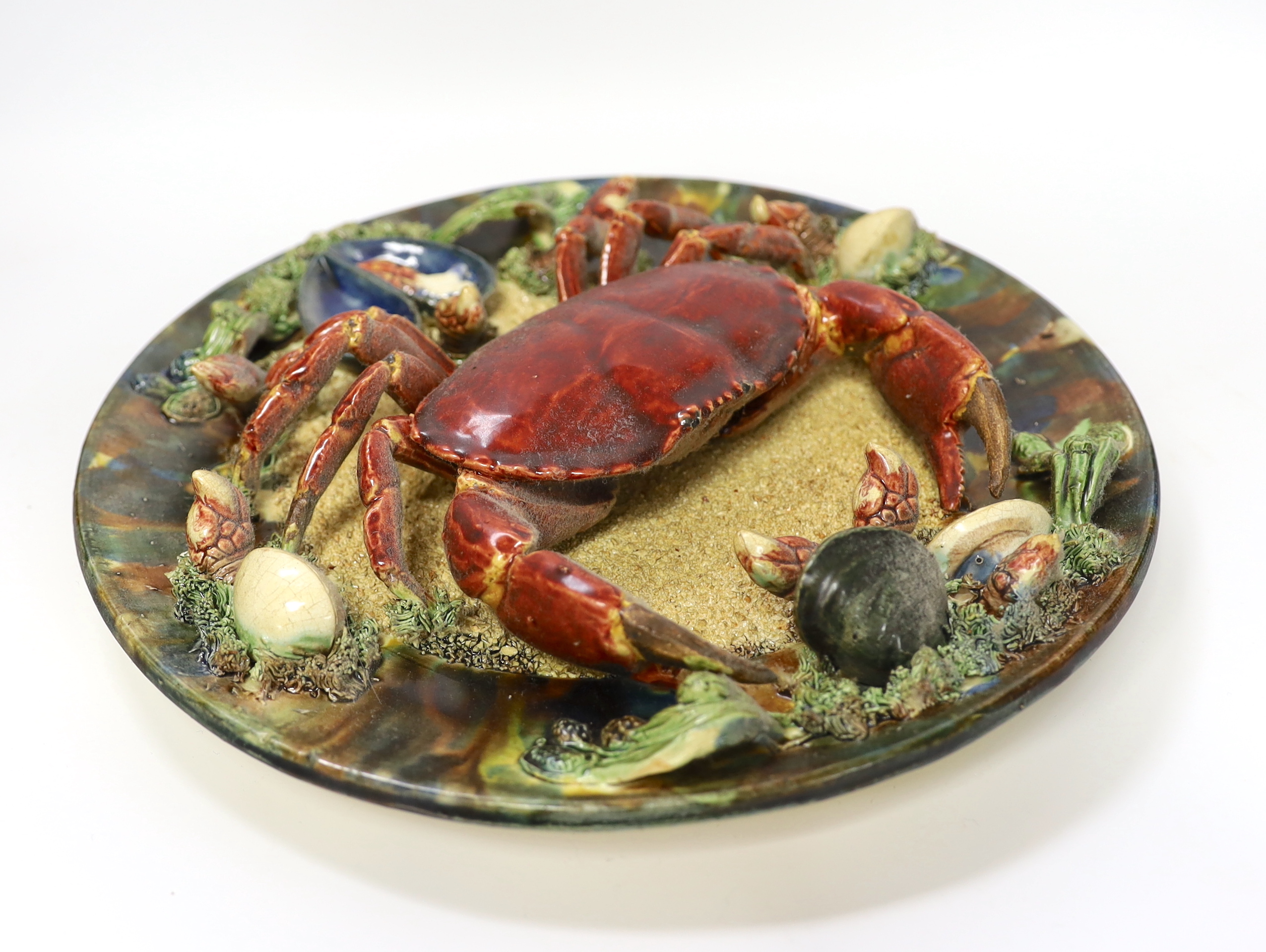 An Alvaro Jose Caldas Da Rainha Palissy ware dish, decorated in relief with a crab and shellfish, stamped to base, 31cm in diameter